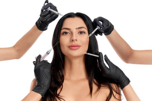 attractive woman getting beauty procedures from two cosmetologist 7502 7947 - مقالات