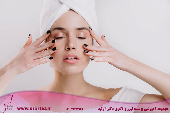 adult woman with healthy skin massages her face prolong youth snapshot girl after shower isolated wall - ماساژ صورت
