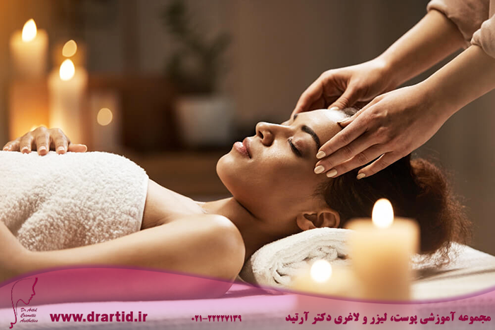 attractive african woman enjoying face massage spa salon 1 - ماساژ صورت