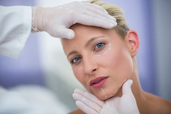 doctor examining female patients face cosmetic treatment 1 - مقالات